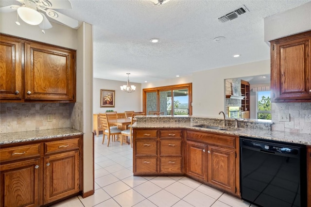 21407 High Dr, Lago Vista, TX 78645 - kitchen featuring black dishwasher, ceiling fan, brown cabinets, light stone counters, and a textured ceiling