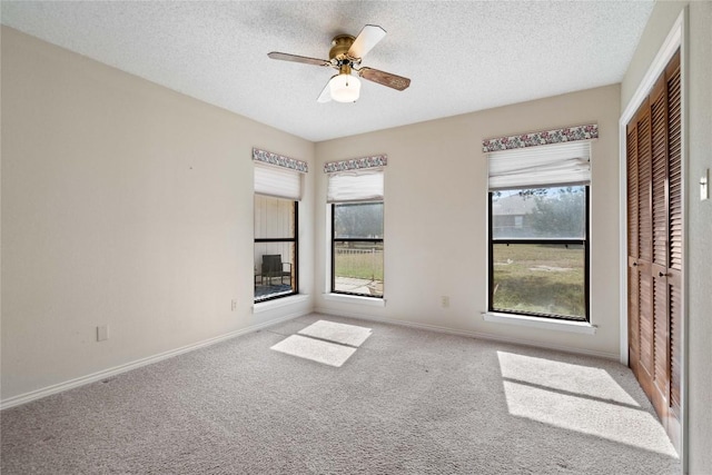 21407 High Dr, Lago Vista, TX 78645 - unfurnished bedroom featuring a textured ceiling, carpet flooring, a closet, and a ceiling fan