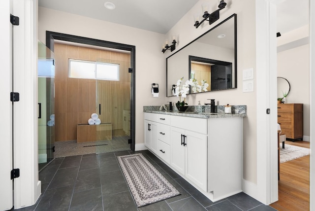 347 Stars And Stripes, Fischer, TX 78623 - bathroom with double vanity, a stall shower, and baseboards