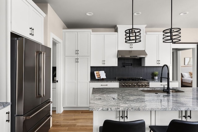 347 Stars And Stripes, Fischer, TX 78623 - kitchen with high quality fridge, a sink, under cabinet range hood, white cabinetry, and backsplash