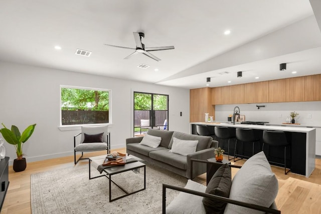 5406 Emerald Forest Dr, Austin, TX 78745 - living room with a ceiling fan, visible vents, vaulted ceiling, recessed lighting, and light wood-style flooring