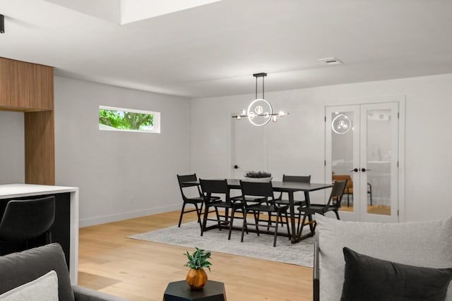 5406 Emerald Forest Dr, Austin, TX 78745 - dining area featuring baseboards, light wood finished floors, and visible vents