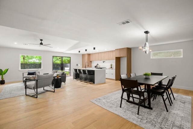 5406 Emerald Forest Dr, Austin, TX 78745 - dining room with recessed lighting, ceiling fan with notable chandelier, light wood-type flooring, and visible vents
