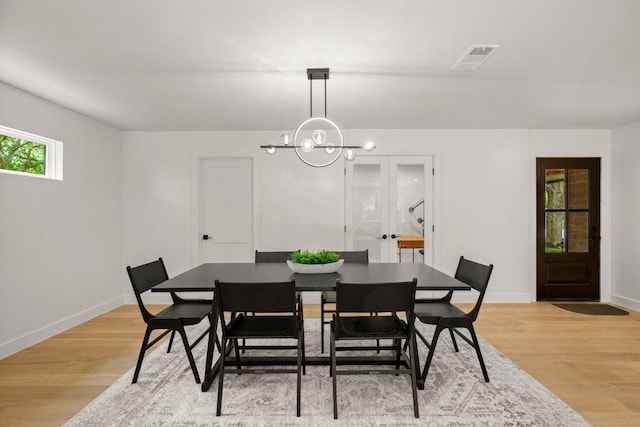 5406 Emerald Forest Dr, Austin, TX 78745 - dining room with baseboards, a chandelier, light wood-style flooring, and visible vents