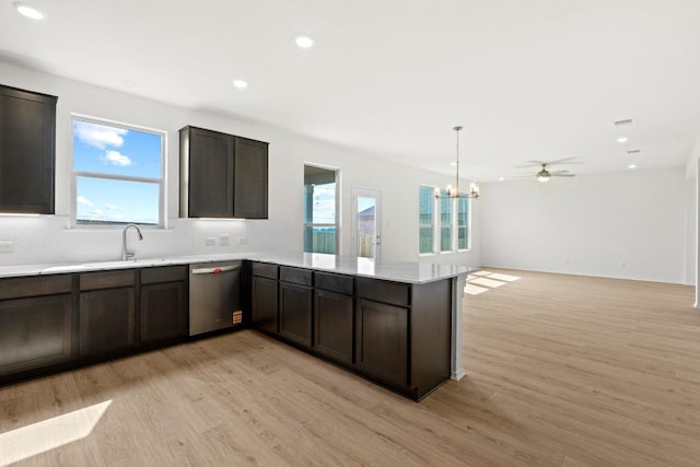 3755 Liberi Ln, Round Rock, TX 78665 - kitchen featuring stainless steel dishwasher, light wood finished floors, a peninsula, recessed lighting, and backsplash