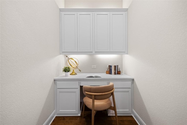 2325 High Lonesome, Leander, TX 78641 - office featuring built in desk, dark wood-type flooring, and a textured wall