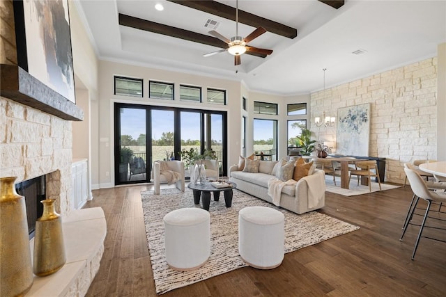 2325 High Lonesome, Leander, TX 78641 - living area featuring a stone fireplace, healthy amount of natural light, a chandelier, wood finished floors, and beam ceiling