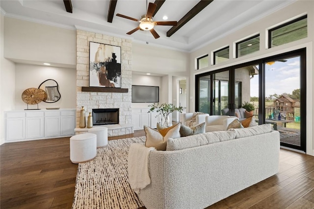 2325 High Lonesome, Leander, TX 78641 - living area featuring beamed ceiling, ceiling fan, a high ceiling, dark wood-style flooring, and a stone fireplace