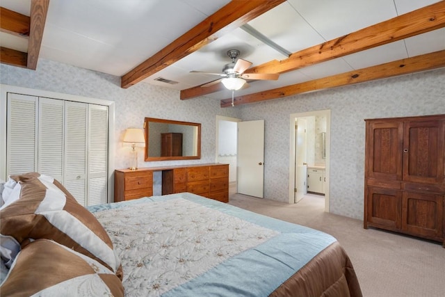 168 Bastrop St, Mcdade, TX 78650 - bedroom with light carpet, beam ceiling, visible vents, wallpapered walls, and a closet