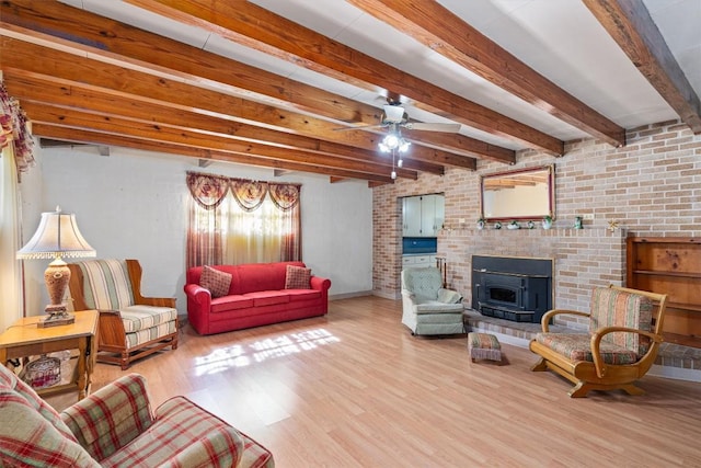168 Bastrop St, Mcdade, TX 78650 - living area featuring baseboards, a ceiling fan, wood finished floors, and beam ceiling