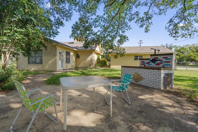 168 Bastrop St, Mcdade, TX 78650 - rear view of property with a lawn, brick siding, fence, and a patio