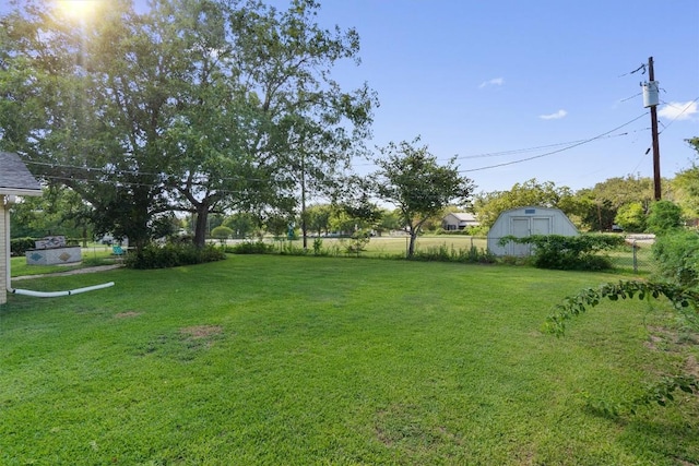 168 Bastrop St, Mcdade, TX 78650 - view of yard featuring an outdoor structure, a shed, and fence