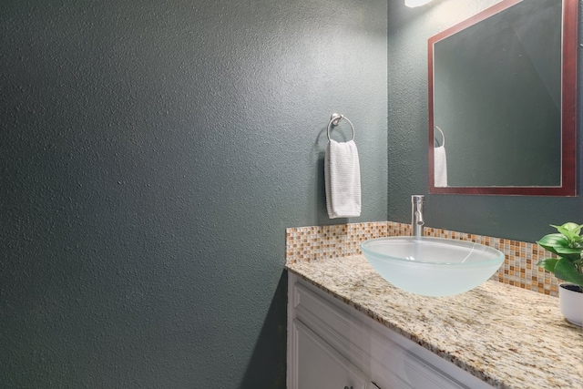 5604 Woodrow Ave Unit 7, Austin, TX 78756 - bathroom featuring tasteful backsplash, vanity, and a textured wall