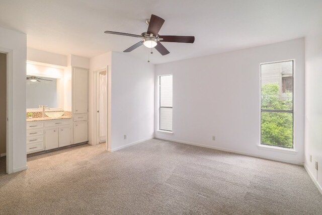 5604 Woodrow Ave Unit 7, Austin, TX 78756 - unfurnished bedroom featuring multiple windows, light carpet, and ensuite bath