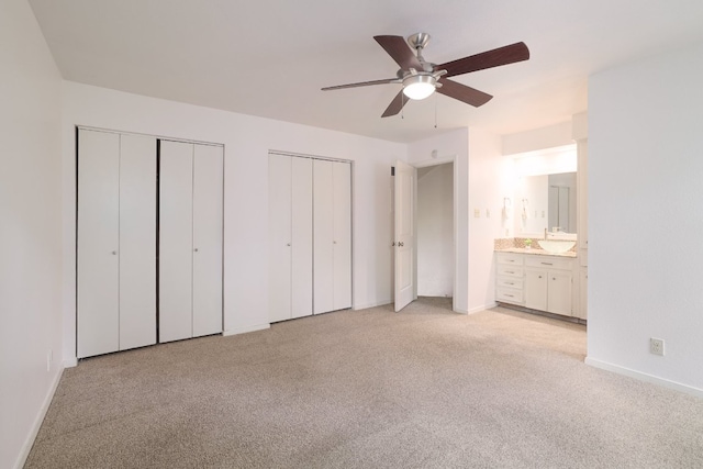 5604 Woodrow Ave Unit 7, Austin, TX 78756 - unfurnished bedroom with two closets, light carpet, a ceiling fan, and connected bathroom