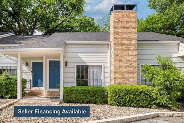 5604 Woodrow Ave Unit 7, Austin, TX 78756 - property entrance featuring a chimney and roof with shingles