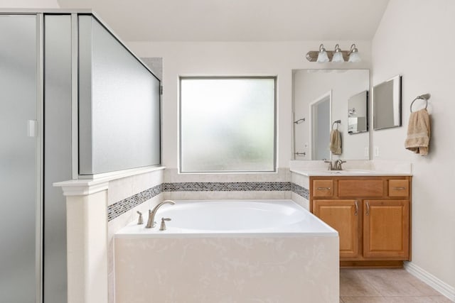 217 Monahans Dr, Georgetown, TX 78628 - full bathroom featuring a garden tub, tile patterned floors, vanity, and a stall shower