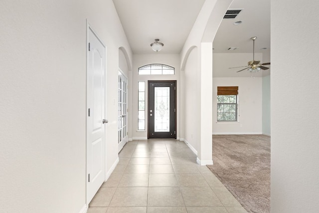 217 Monahans Dr, Georgetown, TX 78628 - entryway with light carpet, light tile patterned floors, arched walkways, and ceiling fan