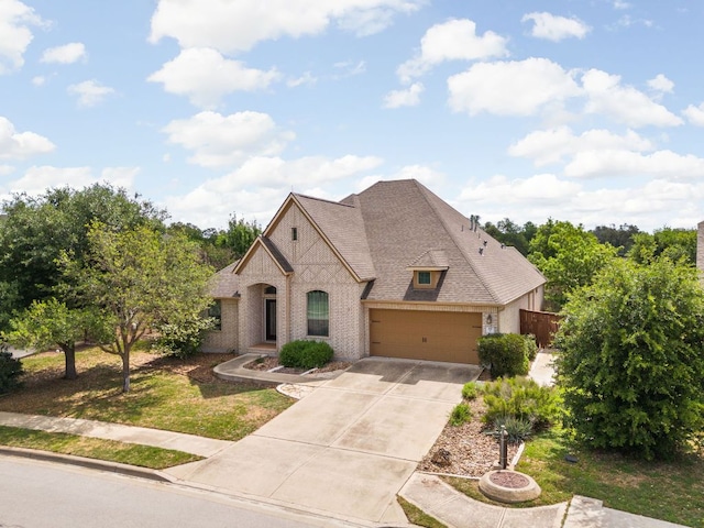 217 Monahans Dr, Georgetown, TX 78628 - french country style house with driveway, brick siding, and an attached garage