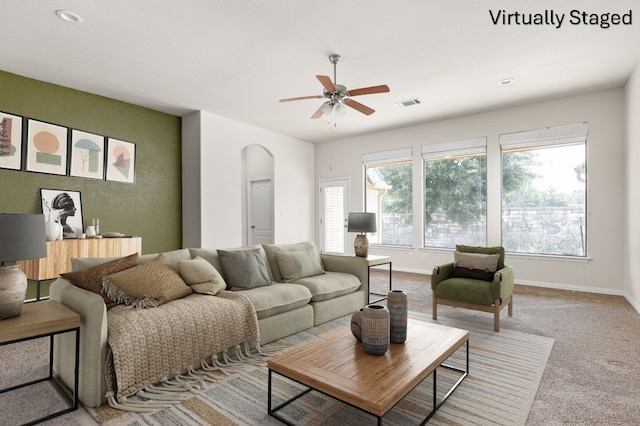 217 Monahans Dr, Georgetown, TX 78628 - living area with arched walkways, a ceiling fan, healthy amount of natural light, carpet floors, and recessed lighting