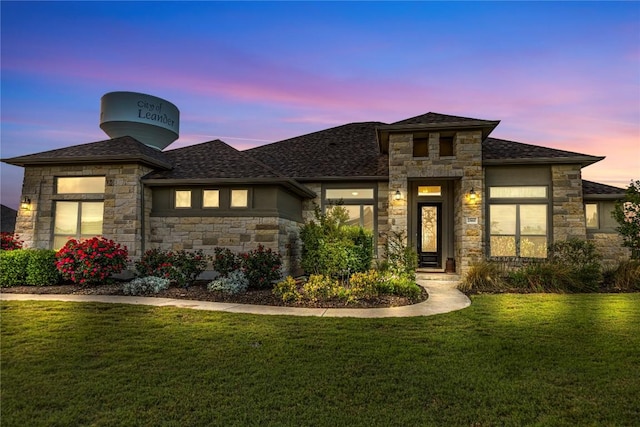 2560 Square Nail Cv, Leander, TX 78641 - prairie-style home with stone siding, a front lawn, and a shingled roof
