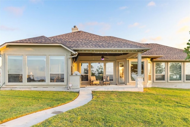 2560 Square Nail Cv, Leander, TX 78641 - back of property featuring ceiling fan, a chimney, roof with shingles, and a yard