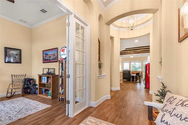 2560 Square Nail Cv, Leander, TX 78641 - entryway with ornamental molding, wood finished floors, a chandelier, arched walkways, and baseboards