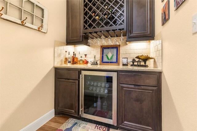 2560 Square Nail Cv, Leander, TX 78641 - indoor dry bar featuring wine cooler, baseboards, wood finished floors, and backsplash