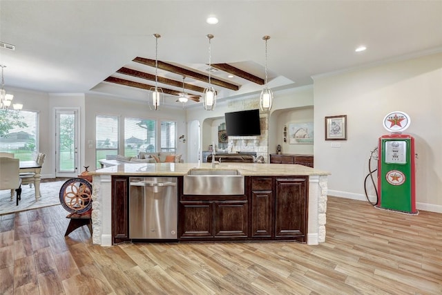 2560 Square Nail Cv, Leander, TX 78641 - kitchen with stainless steel dishwasher, open floor plan, arched walkways, dark brown cabinetry, and light wood-style floors