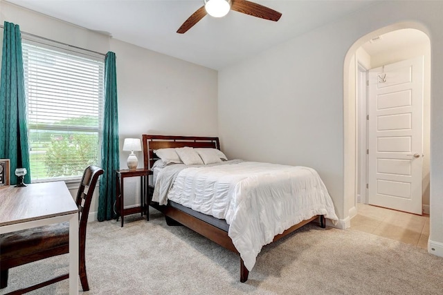 2560 Square Nail Cv, Leander, TX 78641 - bedroom featuring arched walkways, multiple windows, light carpet, and a ceiling fan