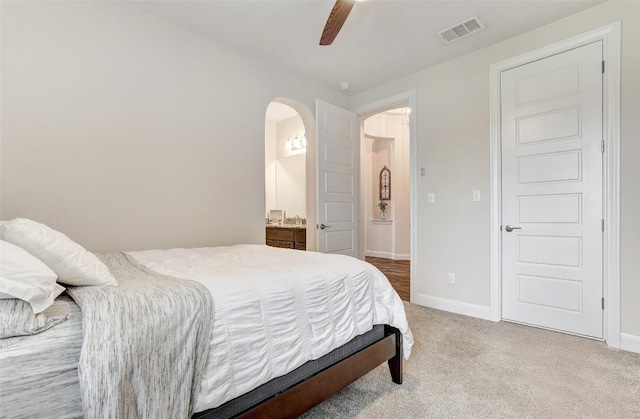 2560 Square Nail Cv, Leander, TX 78641 - bedroom featuring light colored carpet, arched walkways, a ceiling fan, and ensuite bathroom