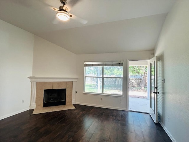 unfurnished living room featuring baseboards, a tile fireplace, hardwood / wood-style flooring, and ceiling fan