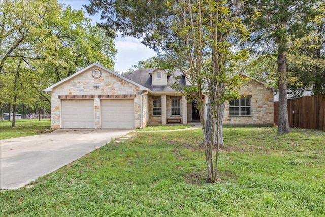 145 Moon Mist Dr, Bastrop, TX 78602 - view of front of home with stone siding, an attached garage, and driveway