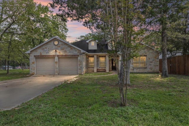 145 Moon Mist Dr, Bastrop, TX 78602 - view of front facade with stone siding, a garage, and concrete driveway