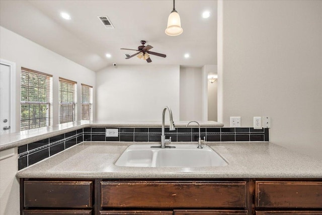 145 Moon Mist Dr, Bastrop, TX 78602 - kitchen with a ceiling fan, dark brown cabinets, recessed lighting, tasteful backsplash, and vaulted ceiling