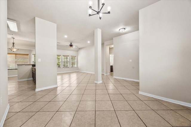 unfurnished living room featuring recessed lighting, baseboards, ceiling fan with notable chandelier, and light tile patterned floors