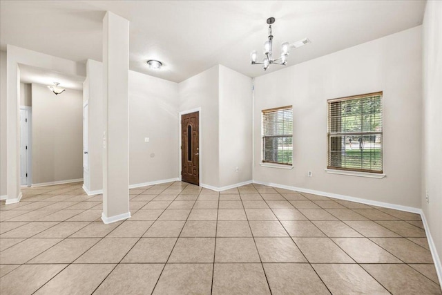 145 Moon Mist Dr, Bastrop, TX 78602 - spare room with a chandelier, light tile patterned flooring, and baseboards