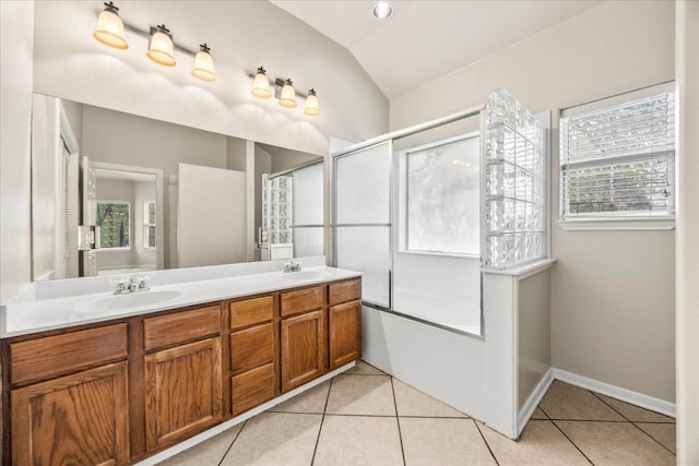 bathroom with lofted ceiling, tile patterned flooring, enclosed tub / shower combo, double vanity, and a sink