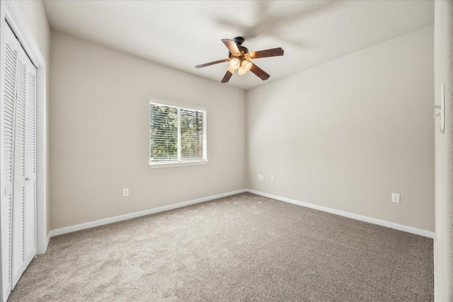 145 Moon Mist Dr, Bastrop, TX 78602 - unfurnished bedroom with carpet, a closet, and a ceiling fan