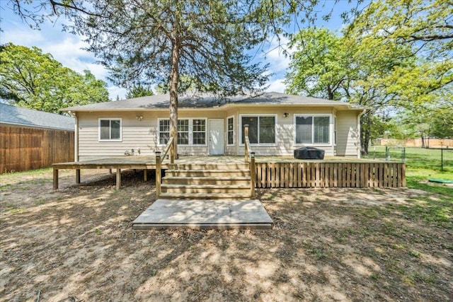 back of house with a wooden deck and a fenced backyard