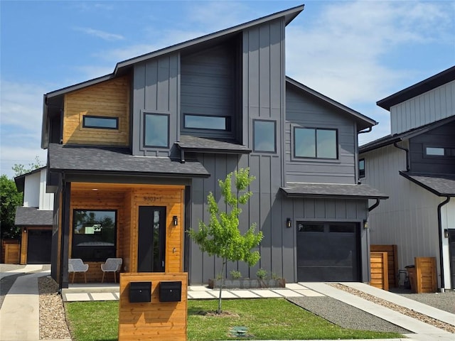 5303 Grover Ave Unit 1, Austin, TX 78756 - contemporary house featuring board and batten siding, a shingled roof, a garage, covered porch, and driveway