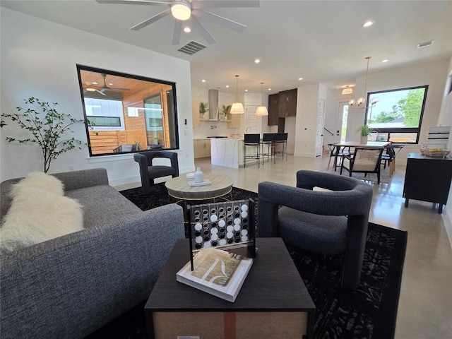 5303 Grover Ave Unit 1, Austin, TX 78756 - living room with ceiling fan, recessed lighting, a chandelier, and concrete floors