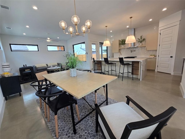 5303 Grover Ave Unit 1, Austin, TX 78756 - dining space featuring finished concrete flooring, recessed lighting, a ceiling fan, and a chandelier