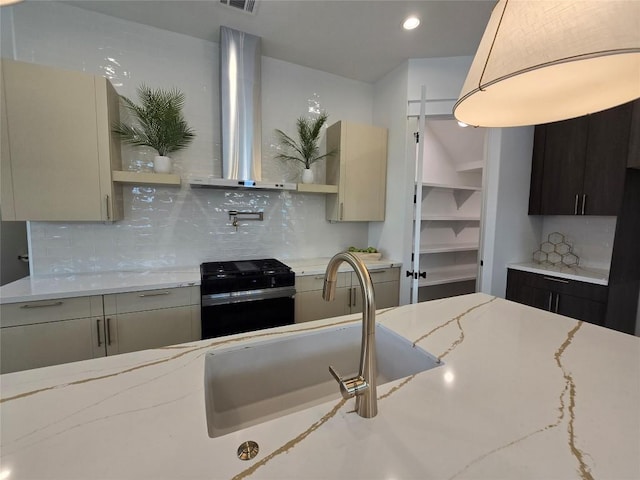 5303 Grover Ave Unit 1, Austin, TX 78756 - kitchen featuring black gas range oven, wall chimney exhaust hood, open shelves, tasteful backsplash, and light stone countertops