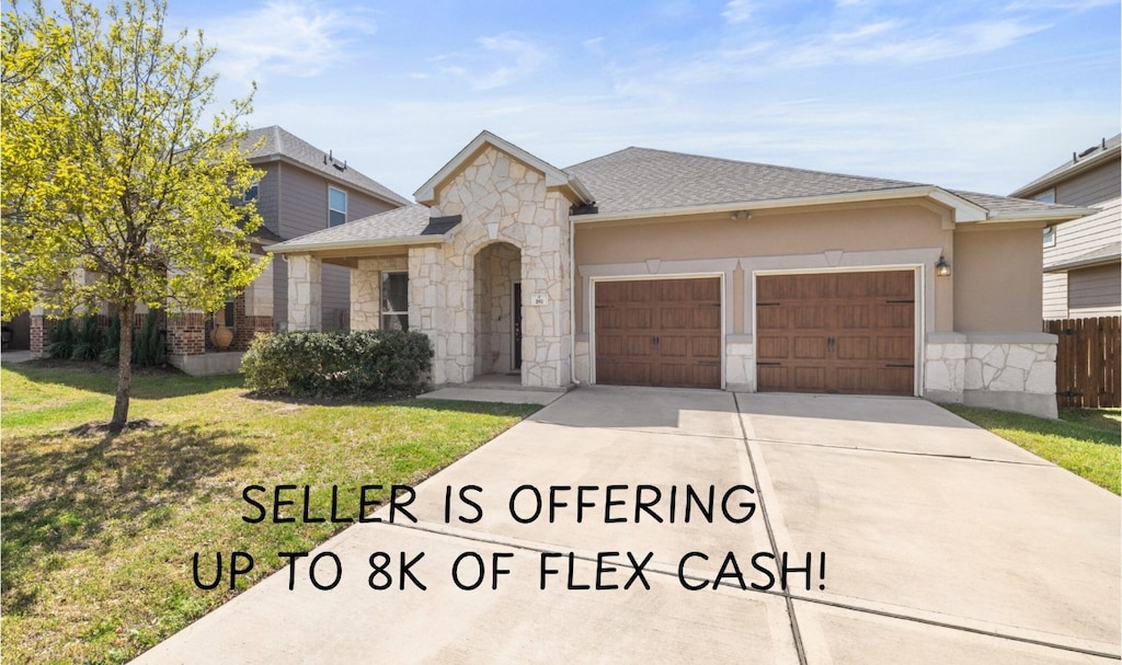 181 Phillips Dr, Kyle, TX 78640 - view of front of property with a garage, stone siding, concrete driveway, a shingled roof, and stucco siding