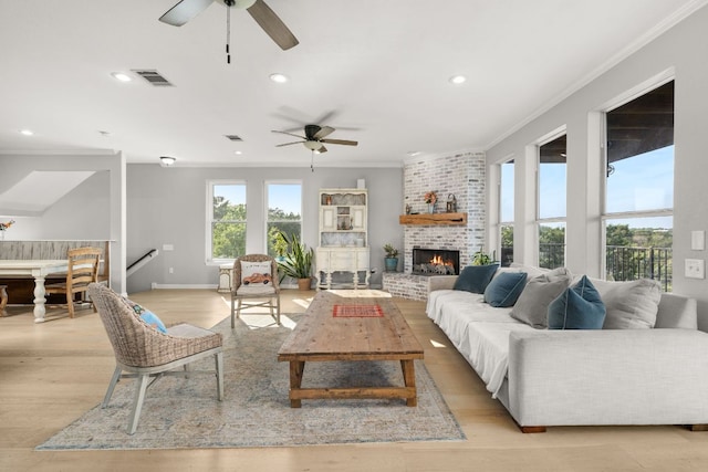 19206 Hornsby Ln, Spicewood, TX 78669 - living area with a ceiling fan, ornamental molding, recessed lighting, light wood-type flooring, and a fireplace
