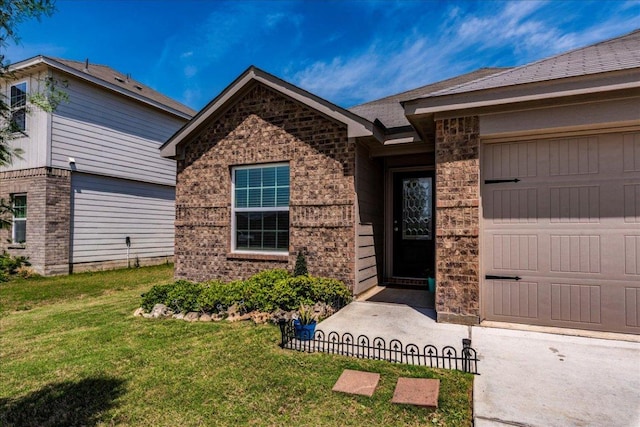 17216 Farmhouse Ln, Elgin, TX 78621 - view of front facade with a front yard, brick siding, an attached garage, and stone siding