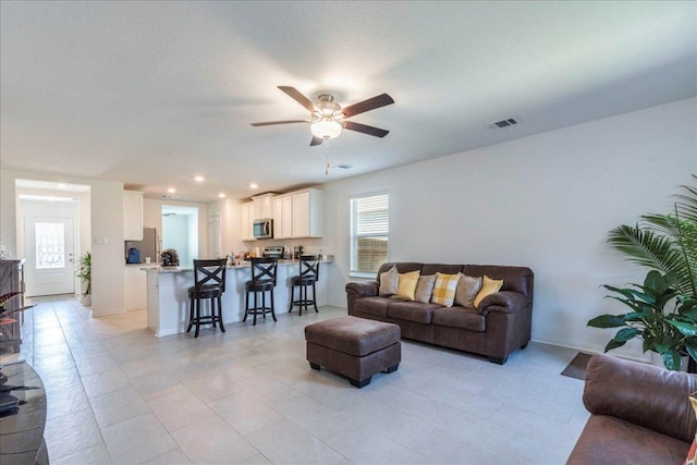 17216 Farmhouse Ln, Elgin, TX 78621 - living area with healthy amount of natural light, a ceiling fan, light tile patterned floors, baseboards, and recessed lighting