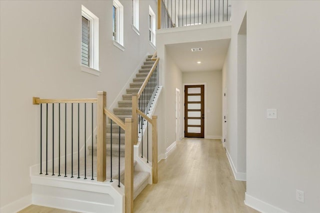 1404 S Brook Dr, Leander, TX 78641 - entryway featuring wood finished floors, stairs, a towering ceiling, and baseboards