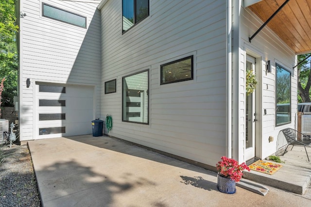 4614 Gillis St Unit 1, Austin, TX 78745 - view of side of home featuring driveway and a garage